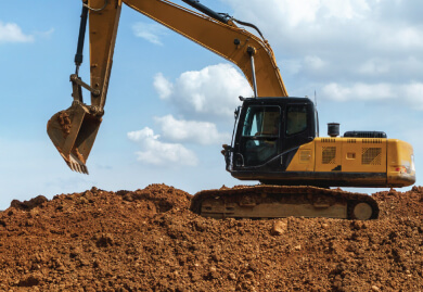 Excavator working on a construction site, representing Slamm Services' comprehensive asset maintenance and industrial solutions.