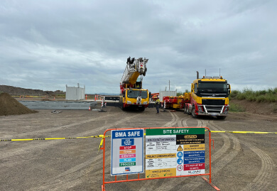 Construction site with safety signage and heavy machinery, highlighting Slamm Services' expertise in road signage and traffic management solutions.